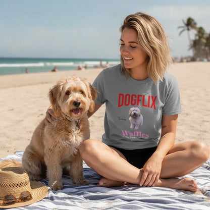 Woman sitting on a beach towel with a golden doodle, wearing the grey DOGFLIX t-shirt
