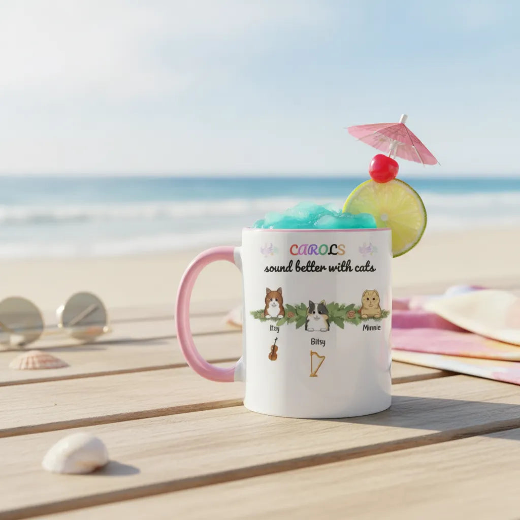 The pink-handled cat mug filled with a blue iced drink, lime and a paper umbrella on a beach boardwalk