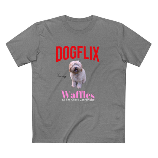 A heather gray short-sleeve t-shirt with a graphic print featuring the red text 'DOGFLIX', a photo of a fluffy light-colored dog, pink text reading 'Waffles as The Chaos Coordinator', and a small black script word 'Training'.