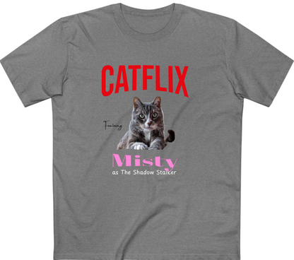 A heather gray short-sleeve t-shirt with a graphic print featuring a tabby cat and the text 'CATFLIX' in red, 'Misty' in pink, and 'as The Shadow Stalker' in white.