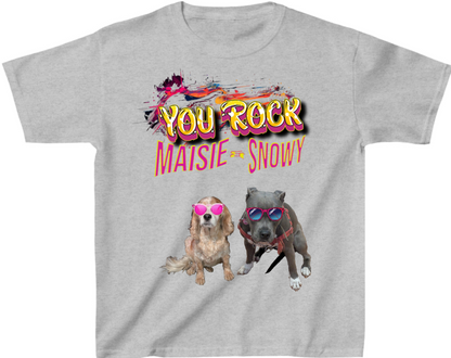 A light heather gray short-sleeve t-shirt with a colorful graphic print. The design features the text 'YOU ROCK MAISIE = SNOWY' in stylized yellow, pink, and black lettering above two dogs wearing pink sunglasses.
