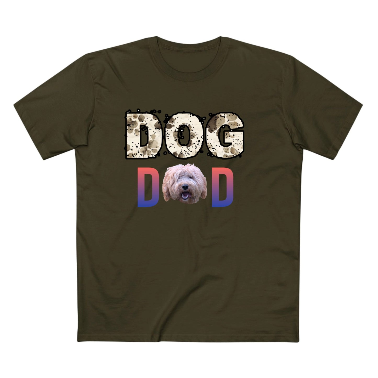 An olive green short-sleeve t-shirt with a graphic on the chest that reads 'DOG DAD'. The 'DOG' text is in a distressed beige pattern, the 'D' is in a blue-to-pink gradient, and the 'D' is also in a blue-to-pink gradient with a shaggy dog face printed inside it.