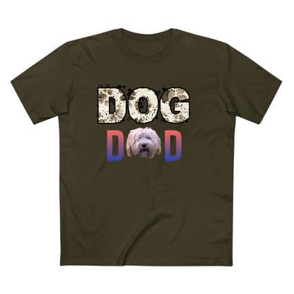 An olive green short-sleeve t-shirt with a graphic on the chest that reads 'DOG DAD'. The 'DOG' text is in a distressed beige pattern, the 'D' is in a blue-to-pink gradient, and the 'D' is also in a blue-to-pink gradient with a shaggy dog face printed inside it.