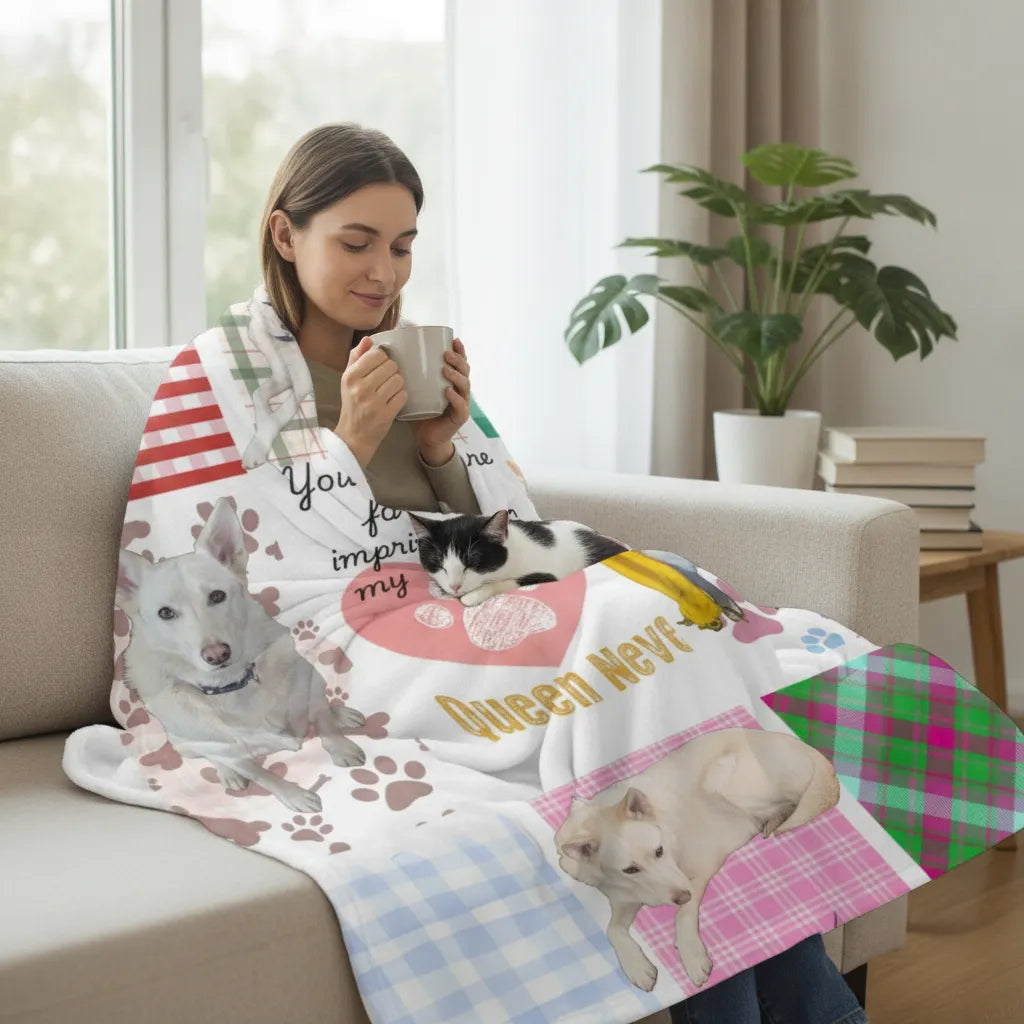 Woman on a sofa wrapped in the patchwork pet photo blanket holding a mug, with a black and white cat beside her